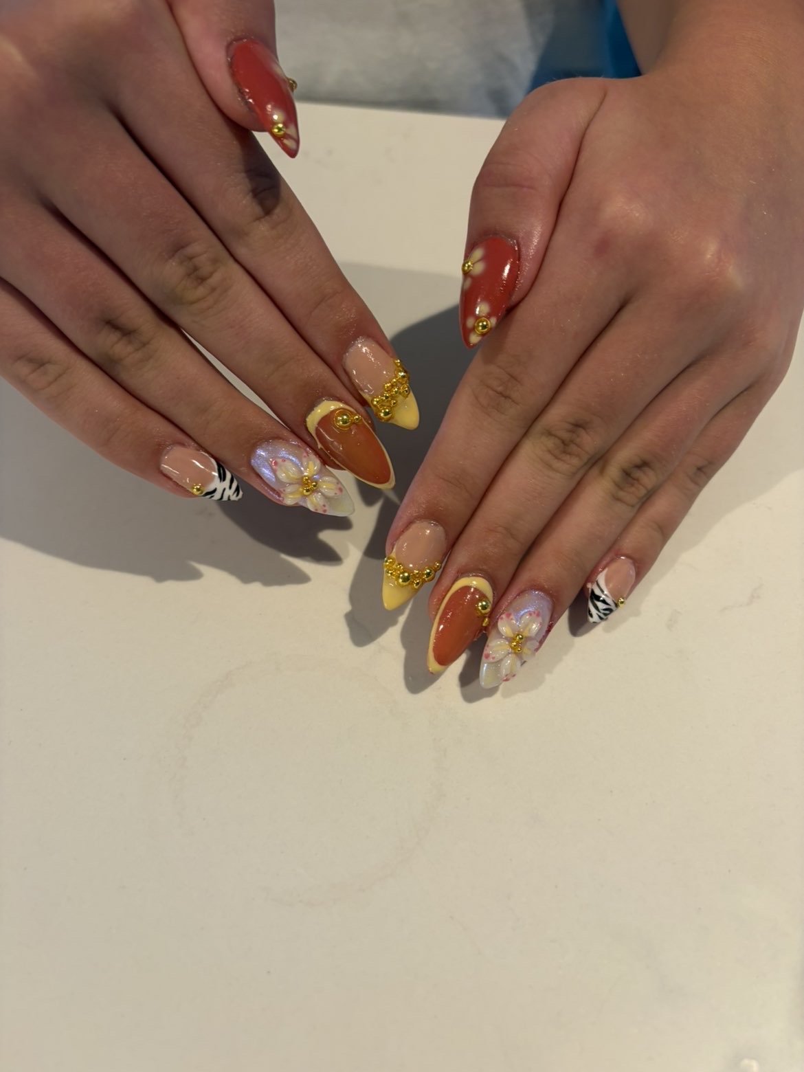 Rust and gold nails with zebra print and florals